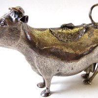 A George II  silver cow creamer by John Schuppe and dated 1758.