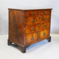 A George II Walnut Chest The Herringbone Inlaid Top above two short and three long drawers with brass handles and escutcheons, raised upon bracket feet, Hmmer £980