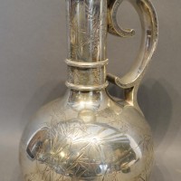 A Victorian Silver Jug Of Bottle Neck Form With Scroll Handle and engraved with storks amongst foliage, London 1879, retailed by the Goldsmiths Alliance Ltd, Cornhill London, 27oz, 26.5cm tall  Hammer: £500